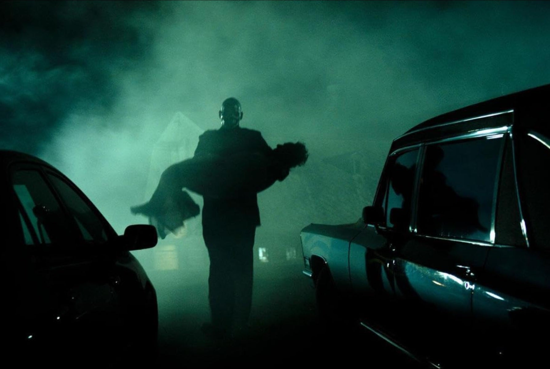 ChromeSkull carries a victim to the hearse